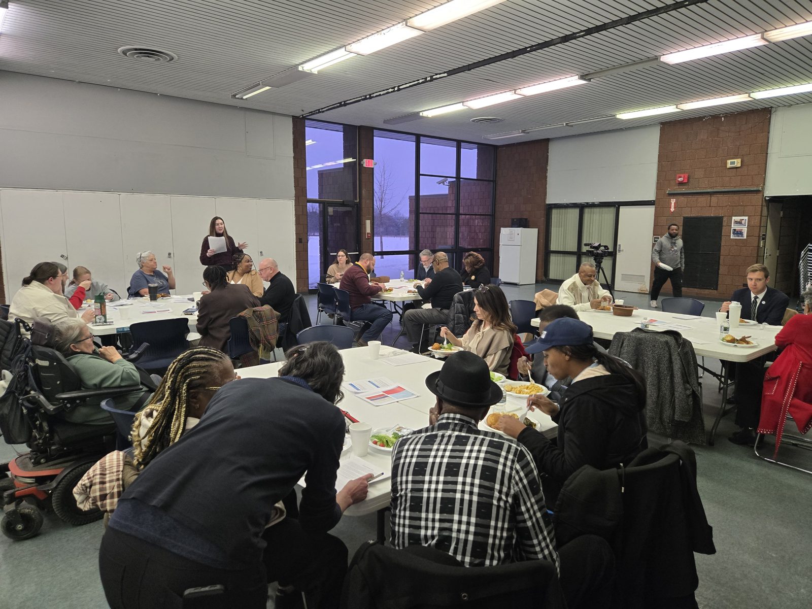 Residents work over neighborhood maps at a community design workshop