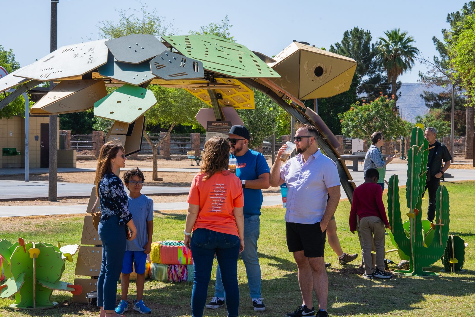 Families gather beneath an artist-designed shade structure in a Phoenix park